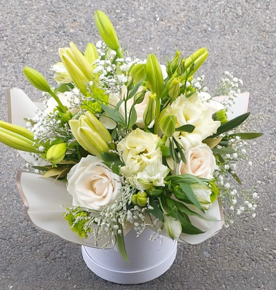 Always Classy - An outstanding hatbox arrangement created using all white flowers with complimentary foliage. Hand delivered with care in and around Cape Town by Shirleys Flower Designs.