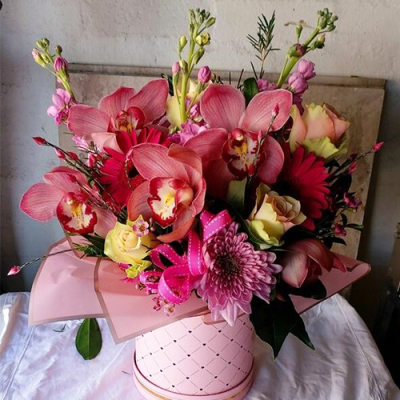 Lush & Wonder - A phenomenal hatbox arrangement created using a mix of pink and green flowers with complimentary foliage. Hand delivered with care in and around Cape Town by Shirleys Flower Designs.